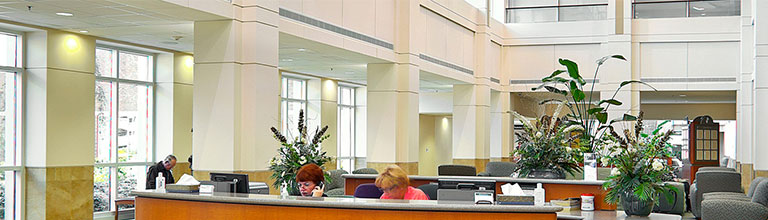 Front desk at Lexington Medical Center's main entrance as a receptionist answers a call.